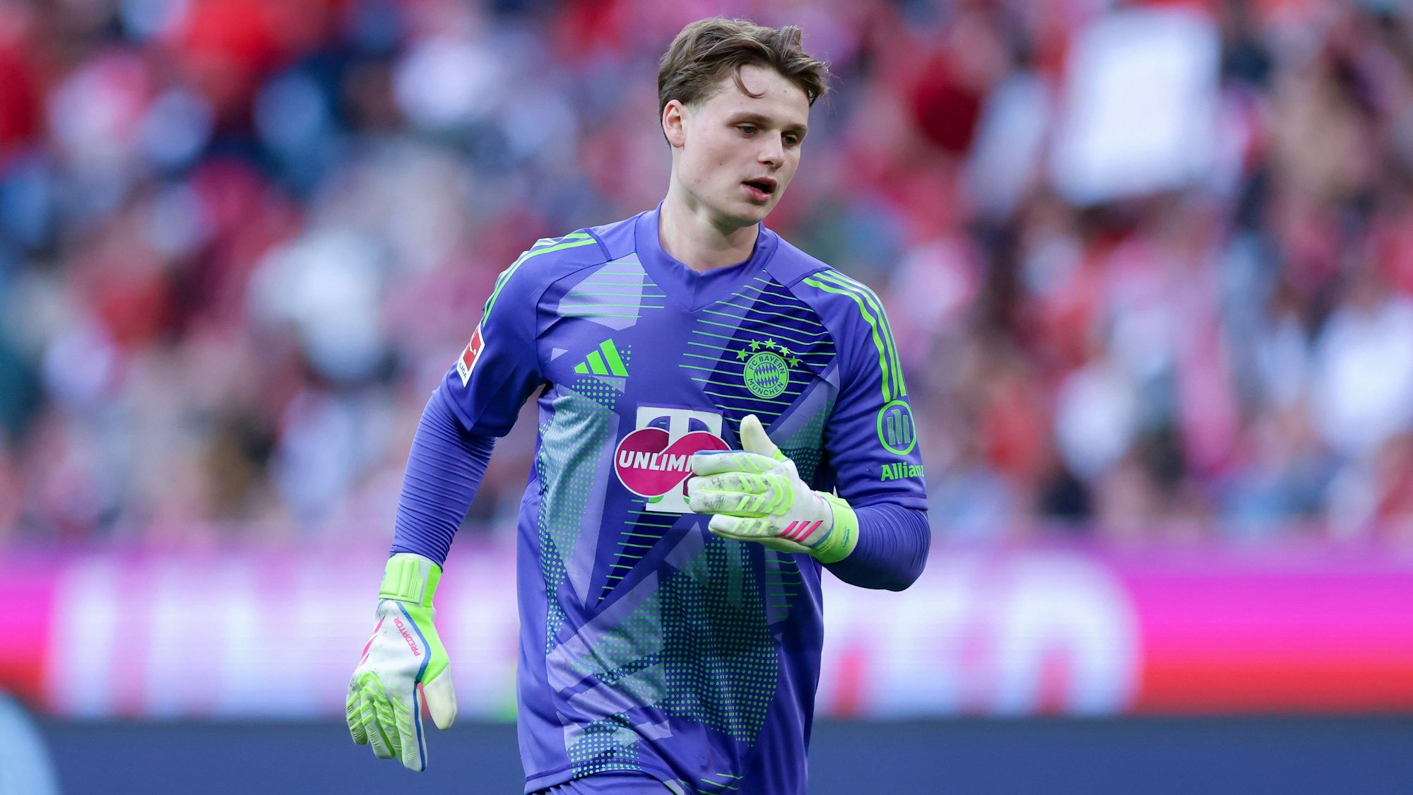 Jonas Urbig beim Bayern-Heimspiel gegen Borussia Dortmund auf dem Rasen.