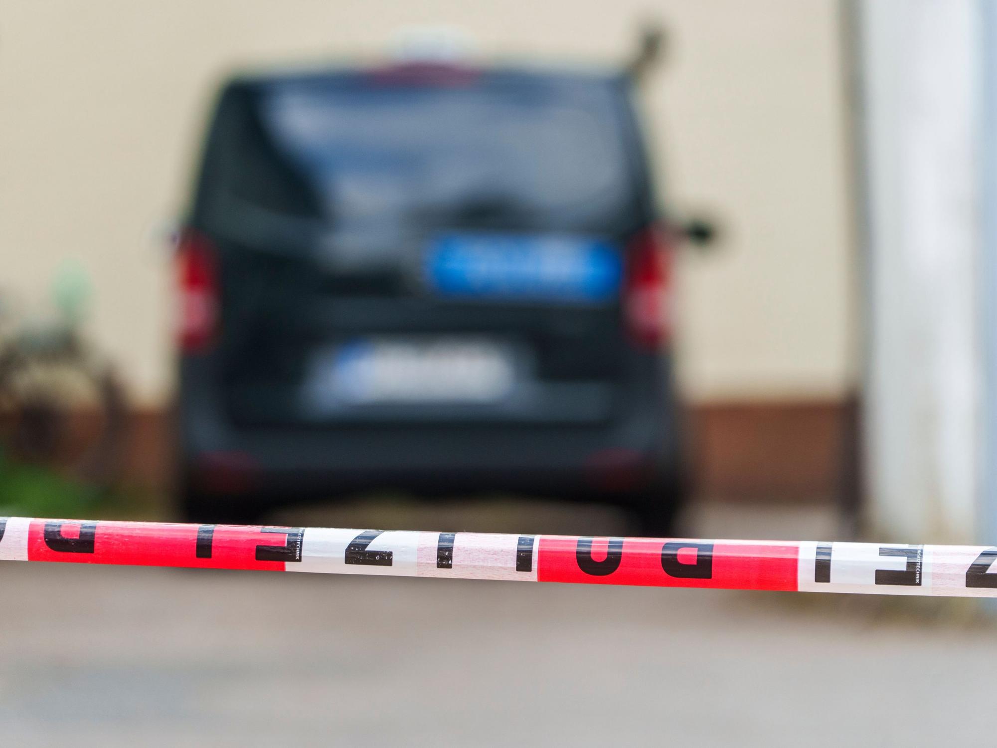 Ein Polizeifahrzeug steht hinter Absperrband.