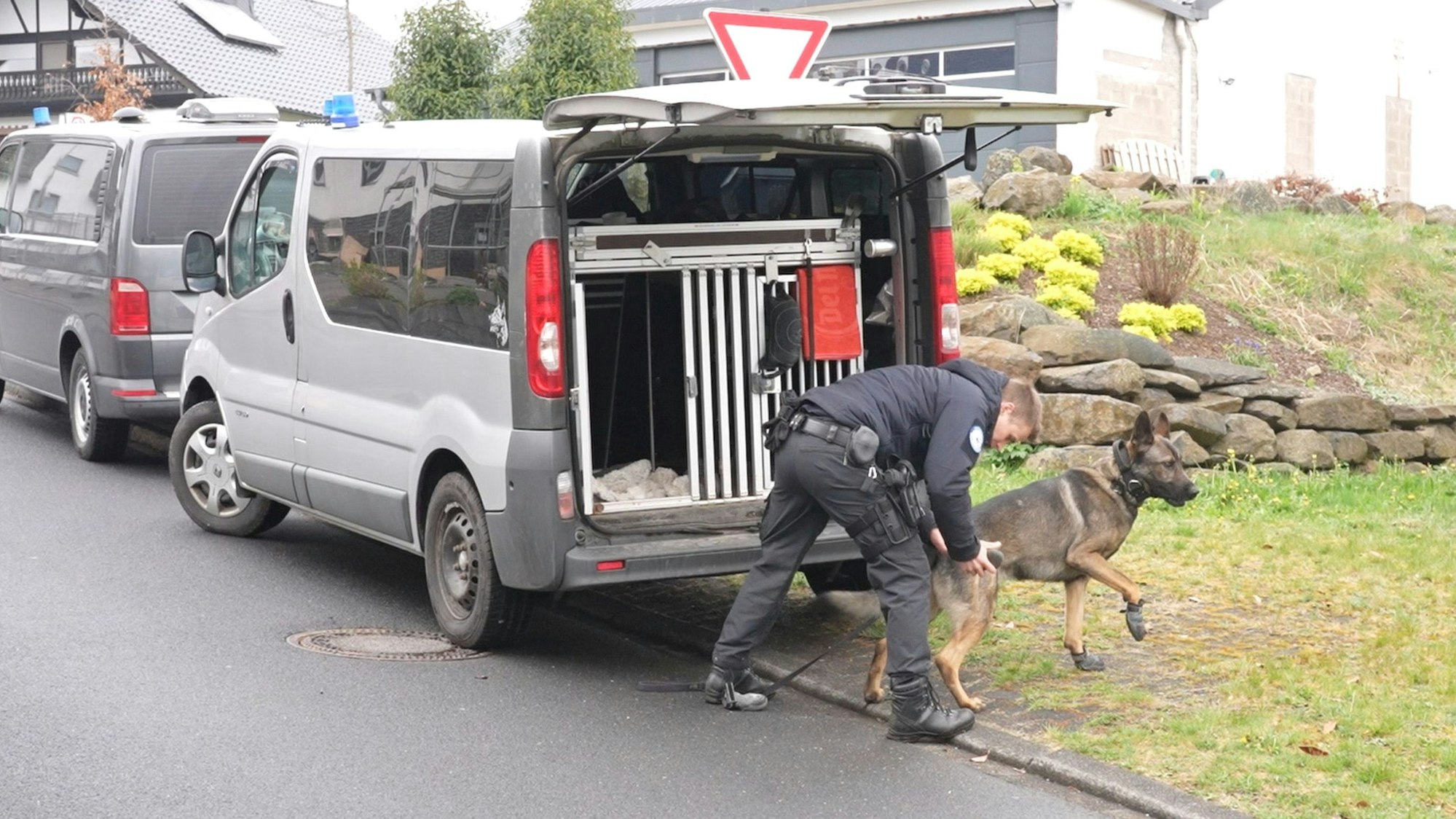 Ein Polizist und ein Suchhund bereiten sich auf einen Einsatz vor.