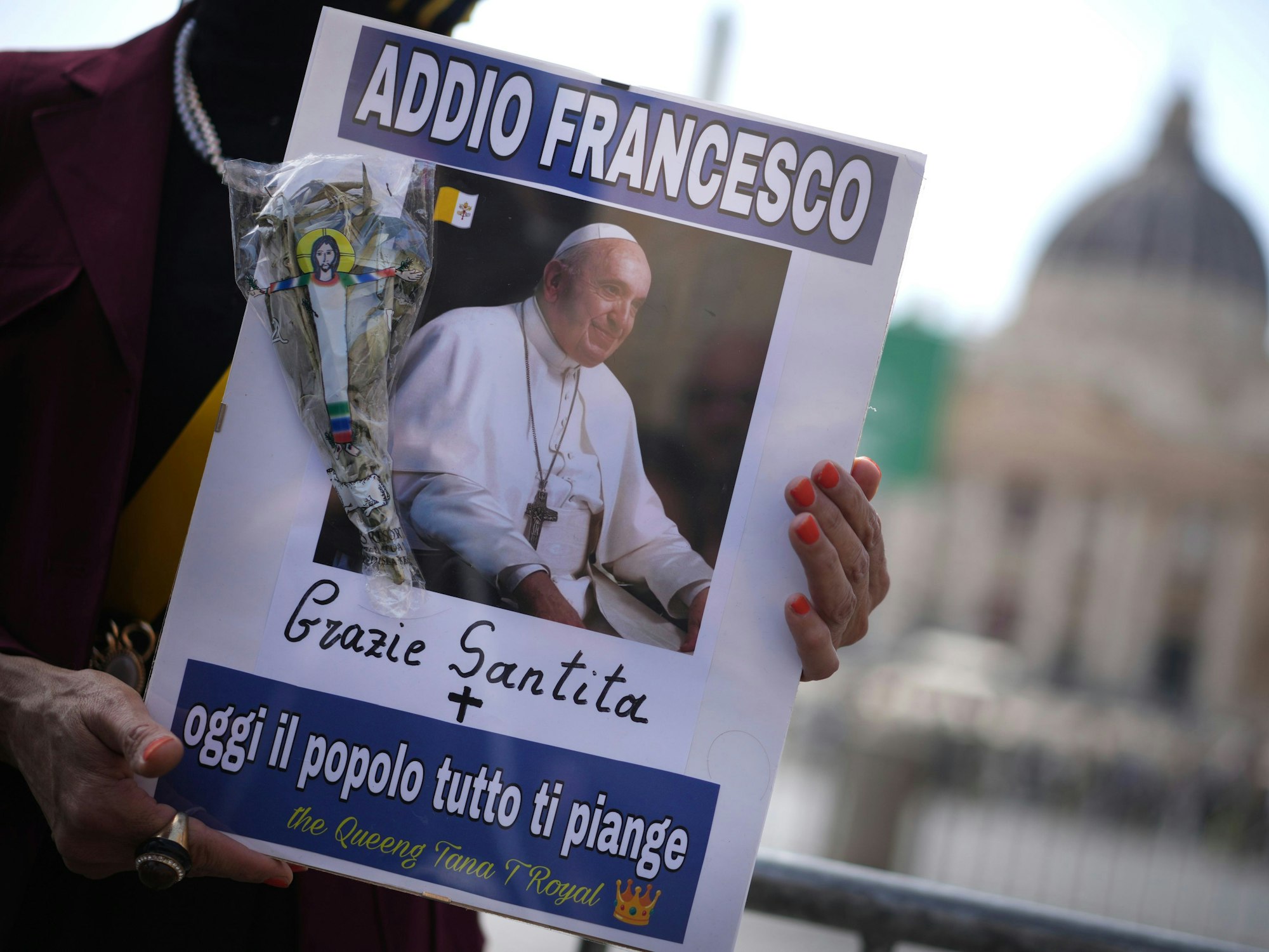 Eine Frau hält ein Bild von Papst Franziskus, auf dem in italienischer Sprache zu lesen ist: "Lebe wohl, Franziskus, danke, Seine Heiligkeit, heute weint das ganze Volk um dich".
