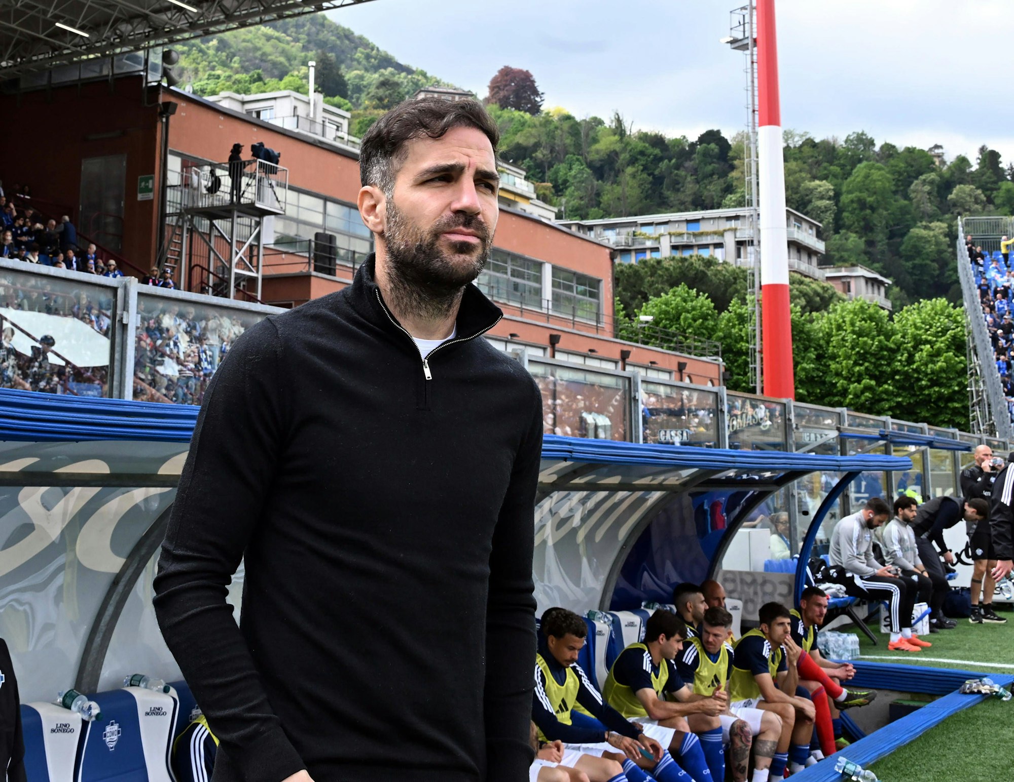 Cesc Fabregas steht vor der Trainerbank.