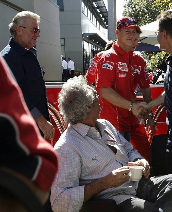 Flavio Briatore und Jean Todt schauen zu, als Schumi Dr. Mario Theißen die Hand schüttelt.