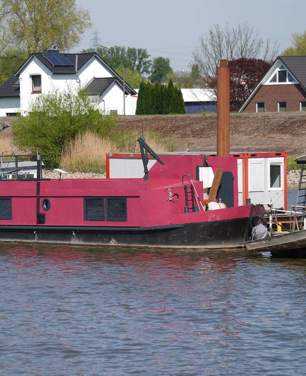 Das pinkfarbene Hausboot, auf dem Alexandra Fröhlich tot aufgefunden worden war, liegt an einem Steg im Holzhafen im Stadtteil Moorfleet.