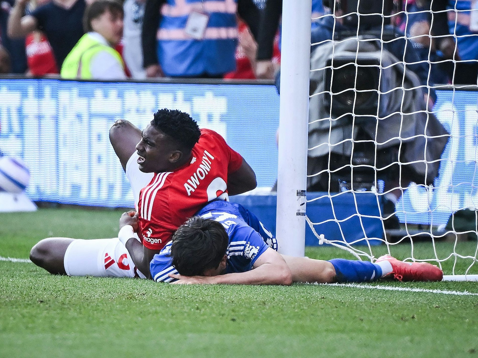 Taiwo Awoniyi liegt mit Schmerzen neben einem Gegenspieler.