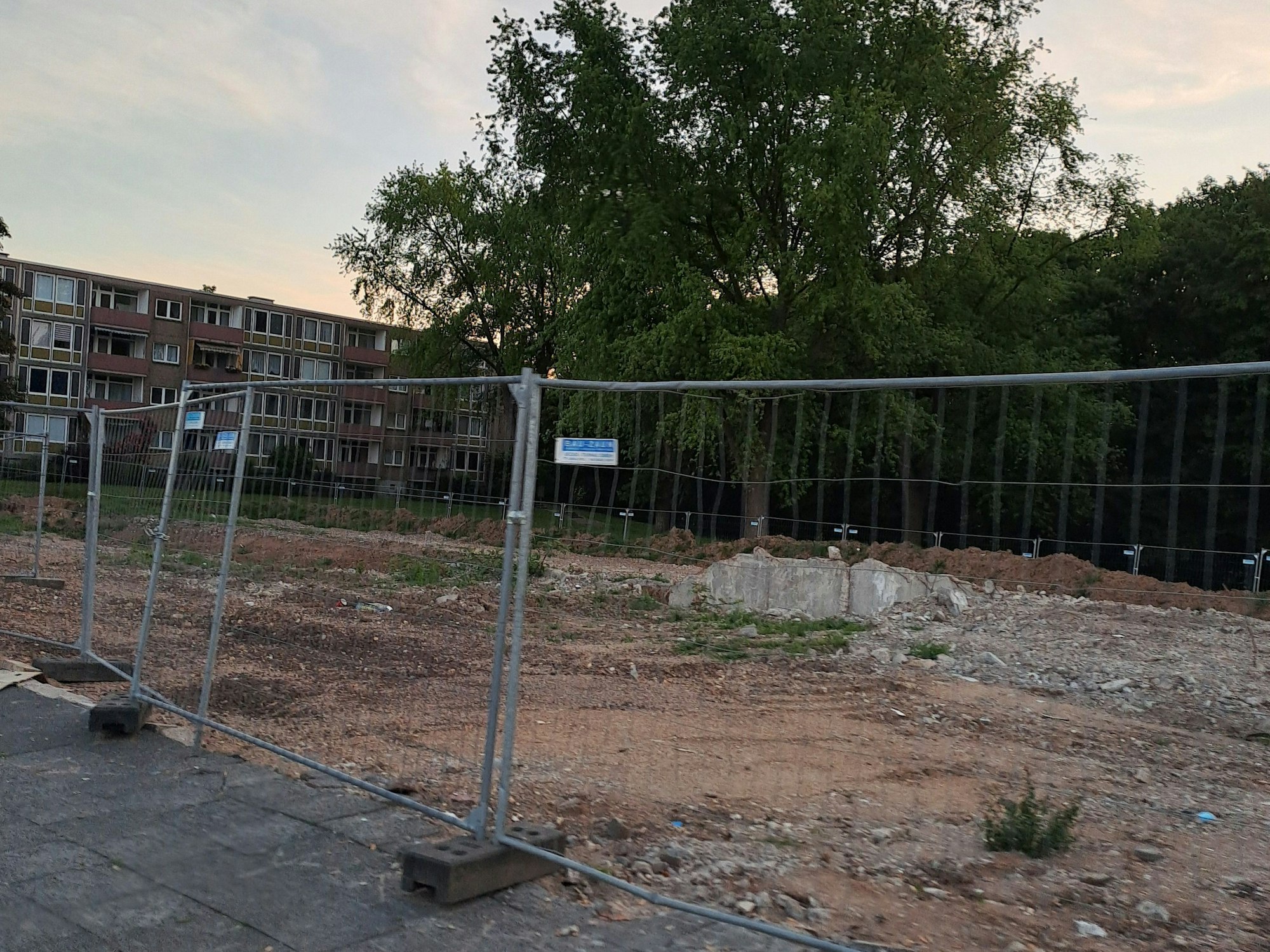 Baustellenzäune im Bereich der Elias-Gut-Straße. Im Hintergrund ist noch ein Block mit den sogenannten „Hollandhäusern“ zu sehen.