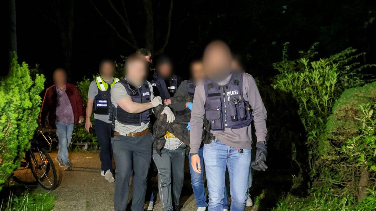 Einsatzkräfte der Polizei führen einen Tatverdächtigen nach seiner Festnahme in Heiligenhaus ab.