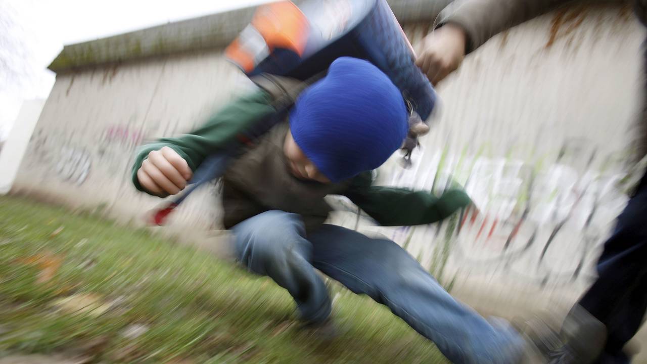 Unter Schülern kommt es immer mehr zu brutalen Übergriffen. Ein Schüler drückt auf dem Schulhof eines Gymnasiums einen anderen Schüler zu Boden (gestelltes Illustrationsfoto).