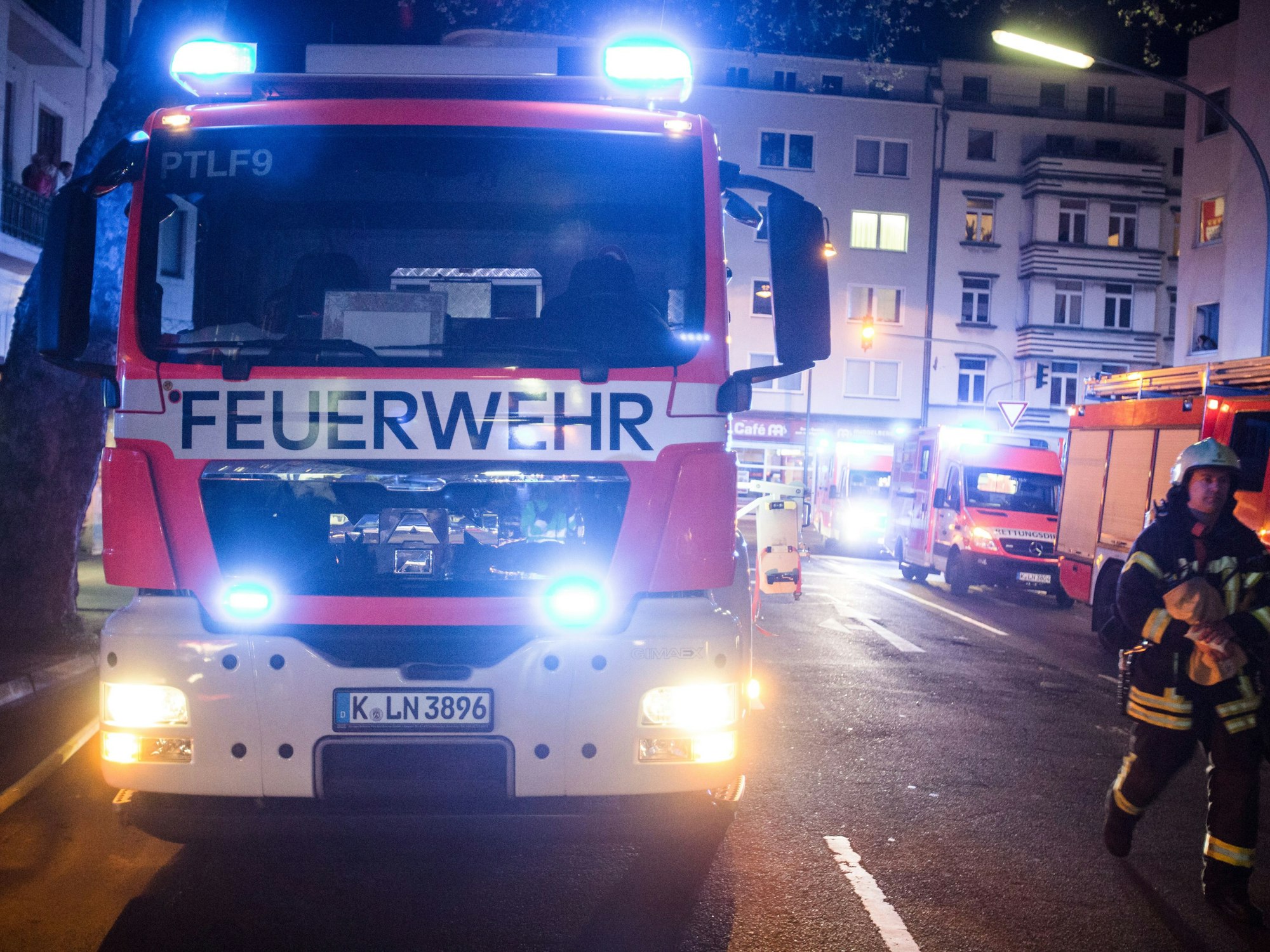 Ein Feuerwehrmann steht neben einem Feuerwehrauto.
