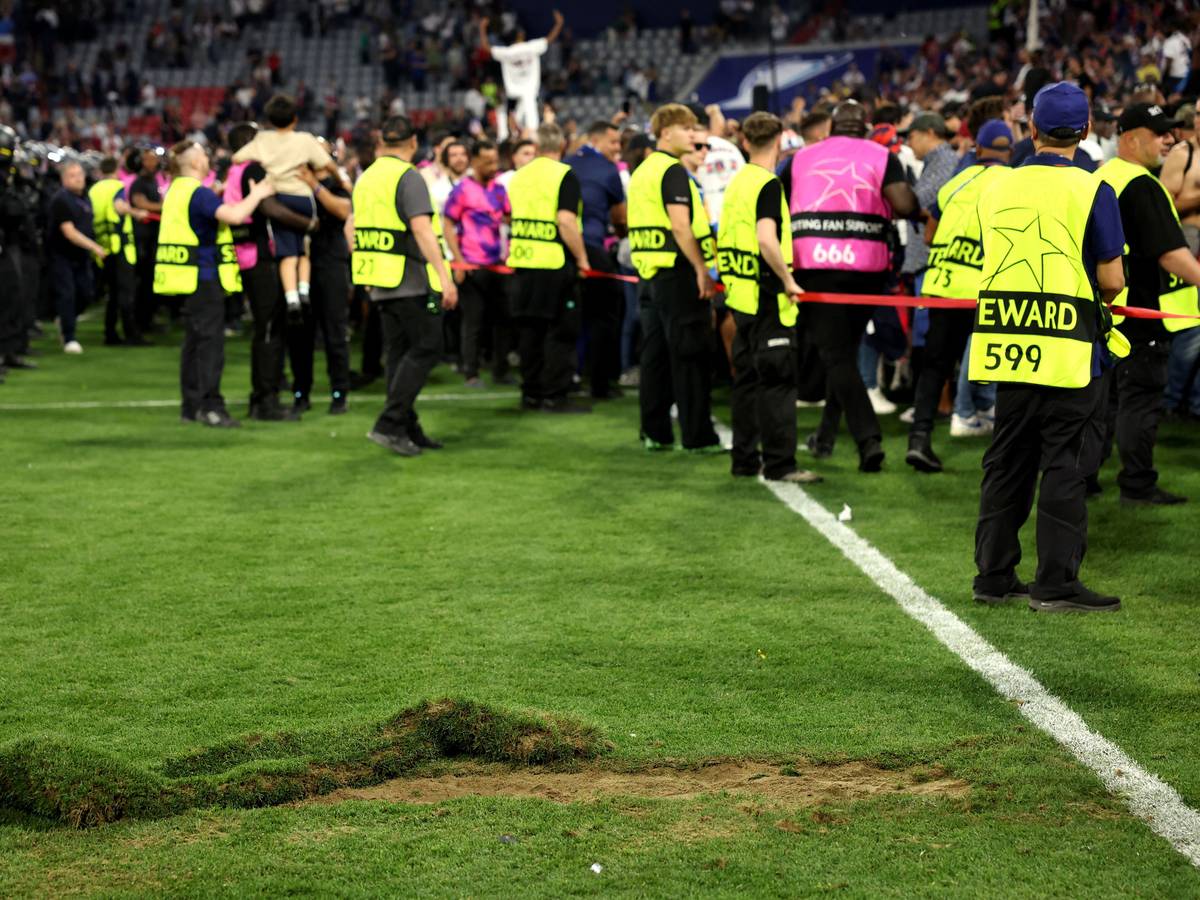 Ein großes Loch klafft nach dem Platzsturm der PSG-Fans im Rasen der Allianz-Arena. Im Hintergrund sind Ornder zu sehen.