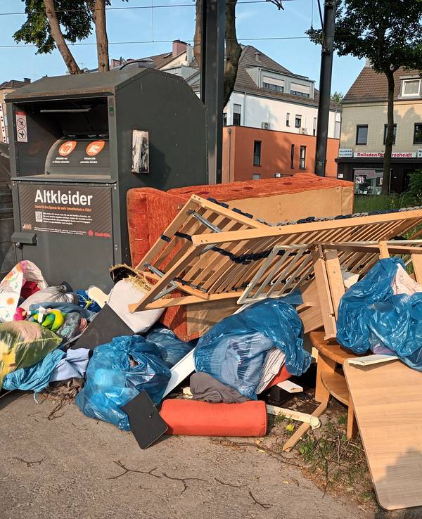 Müll an einem Altkleider-Container
