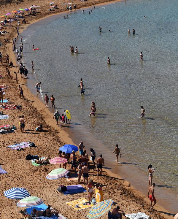 Urlauber und Urlauberinnen an einem Strand auf Menorca
