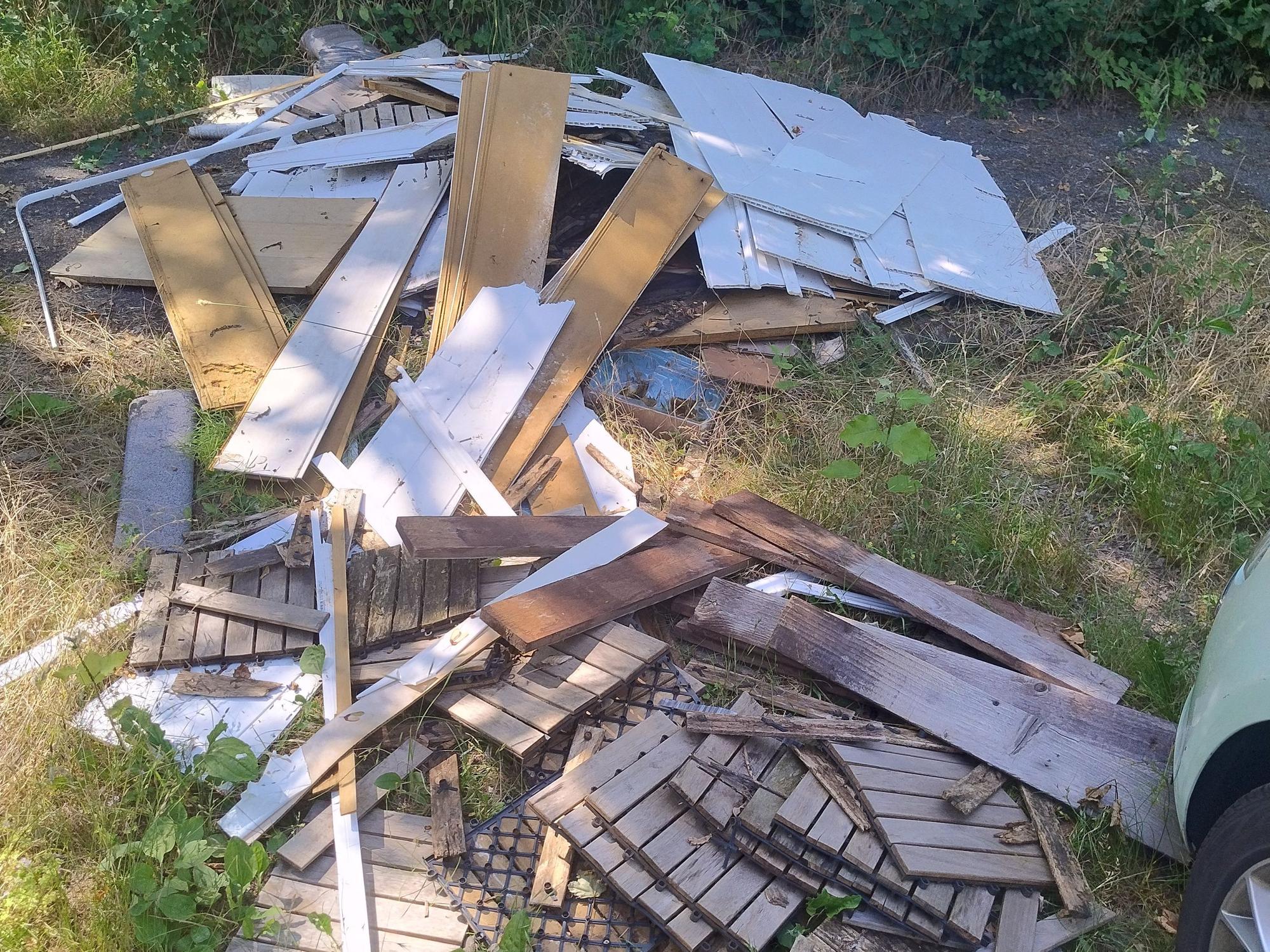 Holzlatten liegen auf einer Wiese.