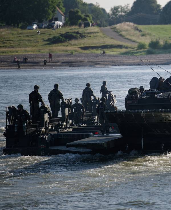 Eine aus Amphibienfahrzeugen gebildete Fähre transportiert Fahrzeuge im Rahmen der Übung „Grand Crossing“ über den Rhein.