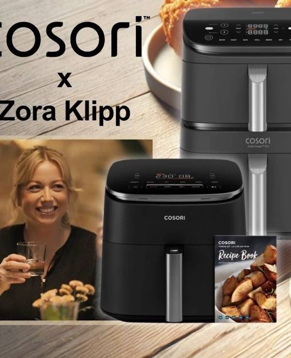 Zora Klipp hält ein Glas in der Hand, daneben Cosori Heißluftfritteusen der Kollektion Cosori x Zora Klipp vor lecker zubereiteten Speisen wie knusprigem Hähnchen und Pommes frites.