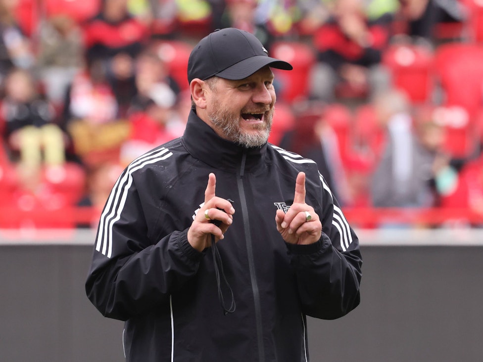 Steffen Baumgart hebt beide Zeigefinger im Union-Training.
