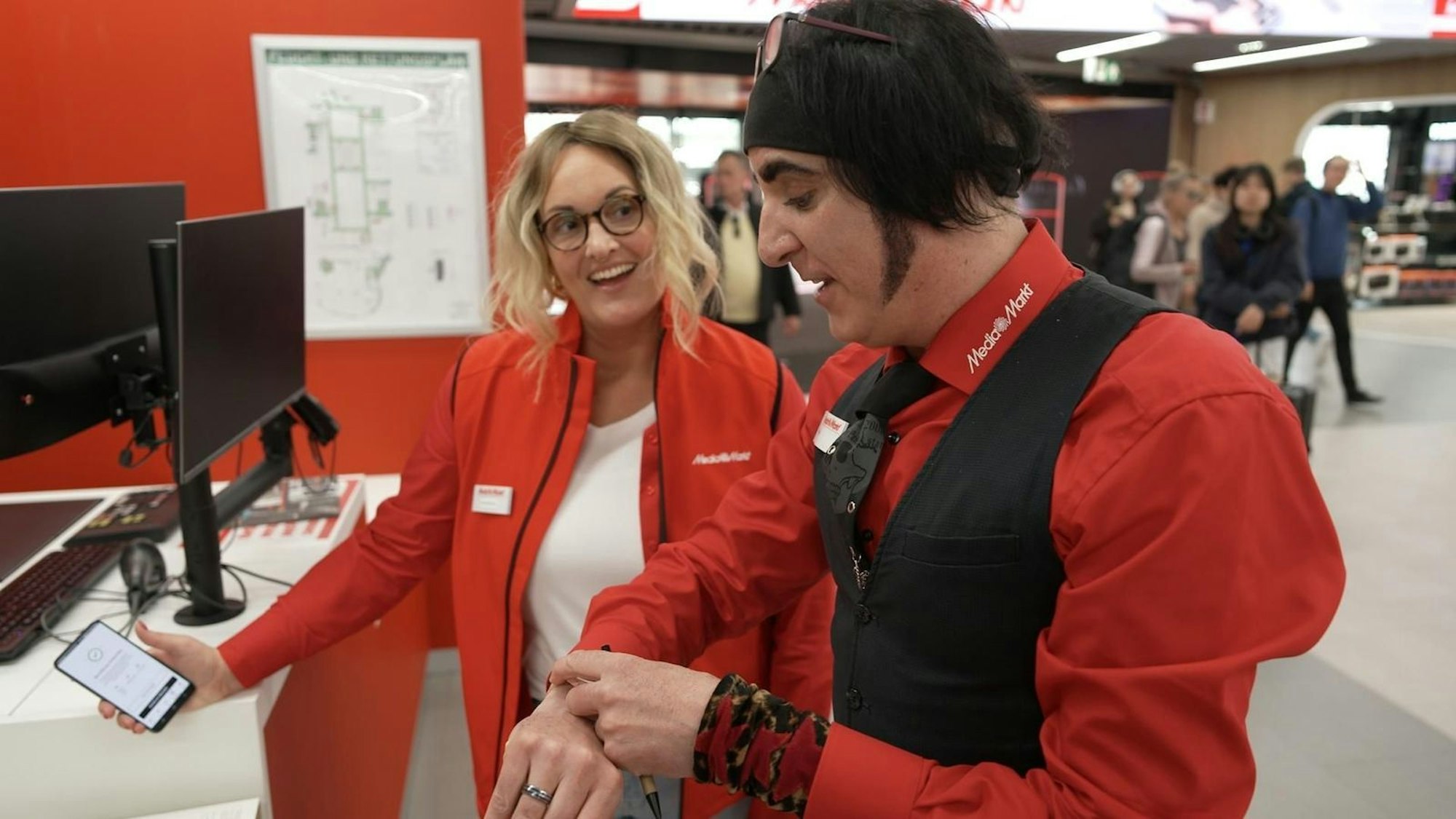 Ein echtes Erlebnis: Berit ist als Probearbeiterin Svenja total begeistert von Welcome Mager Leif, der seine Kunden auch mal mit einer Gesangseinlage fesselt. (Bild: RTL)