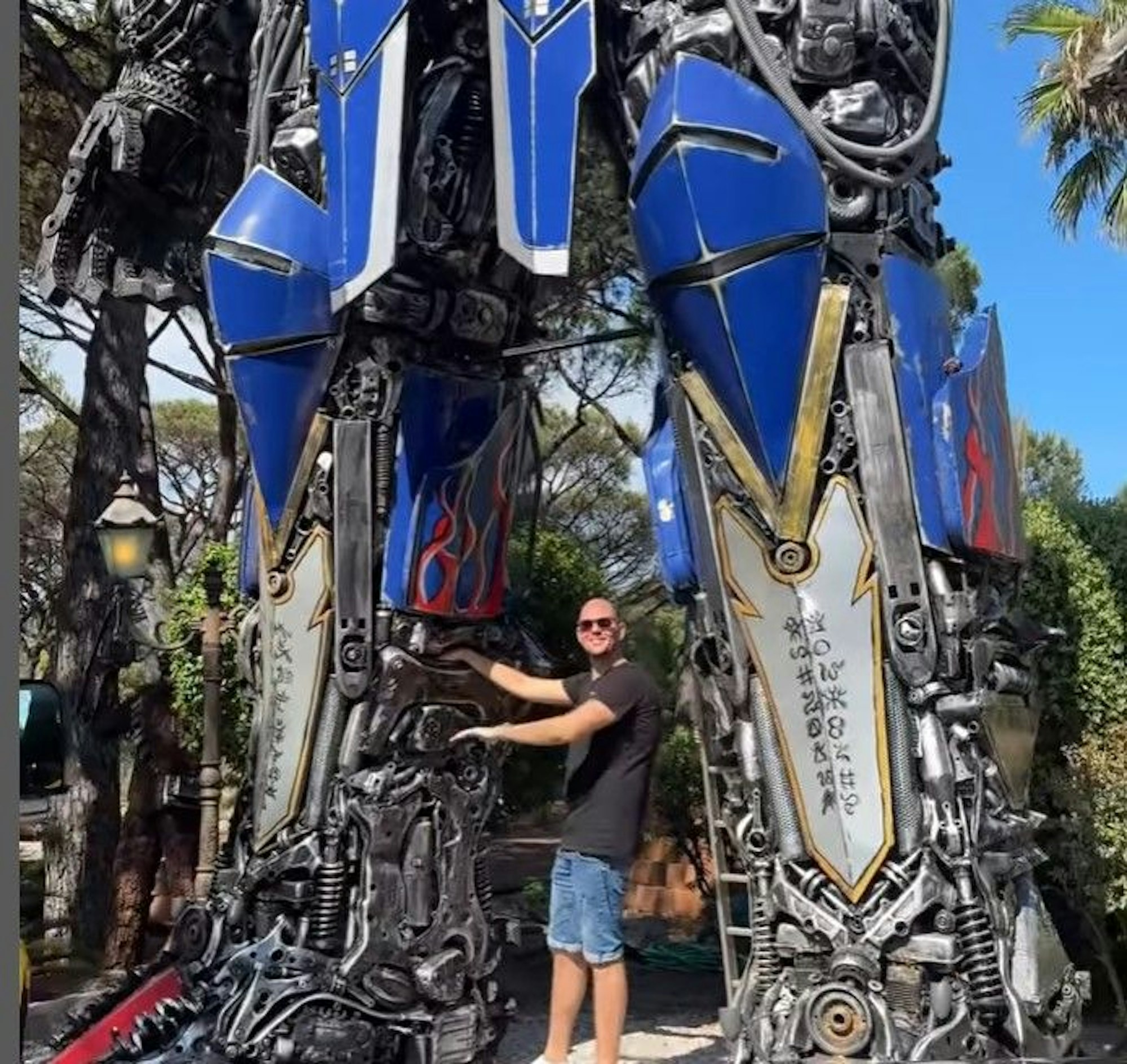 Ein Mitarbeiter der Geissens schraubt an einer überdimensionalen Transformer-Figur.