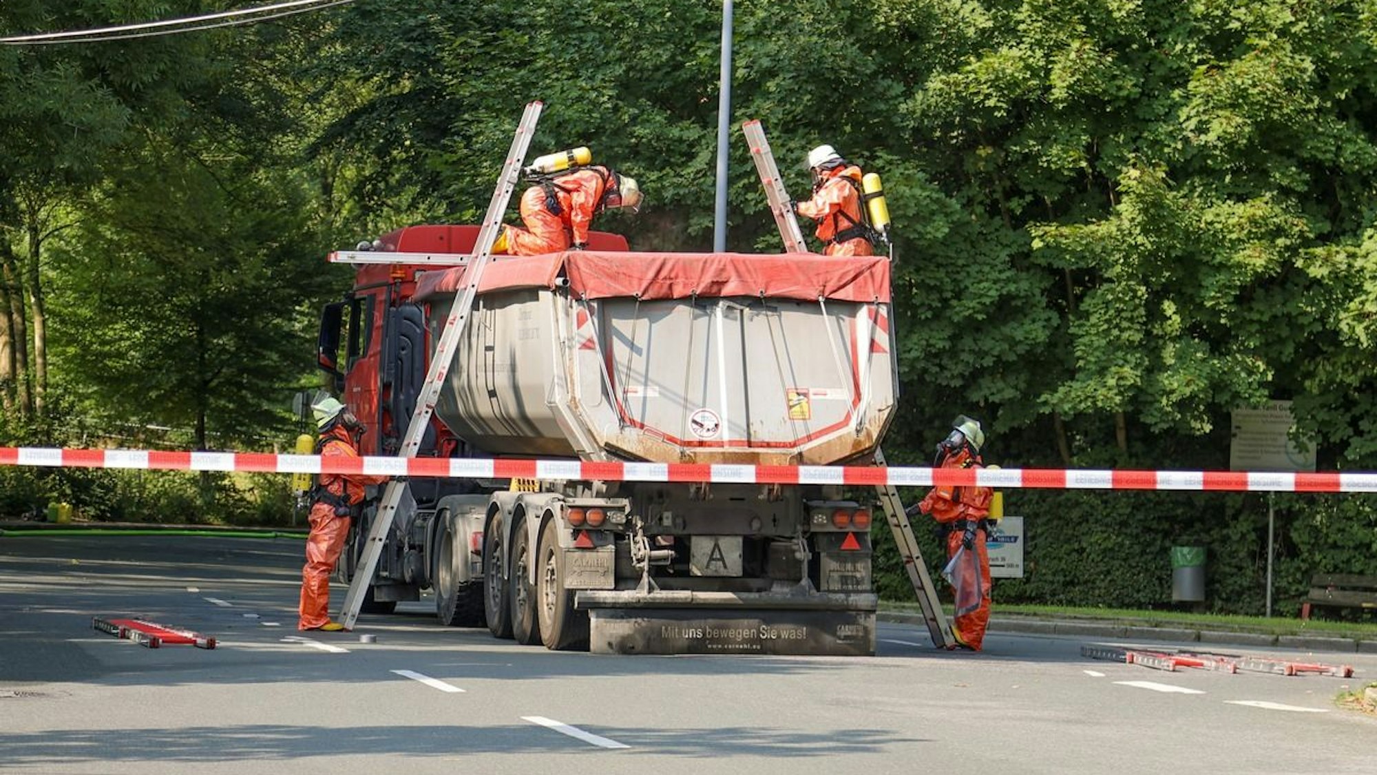 Ein LKW, aus dem Ammoniak austritt, steht auf einer Straße. Feuerwehrleute sind im Einsatz.