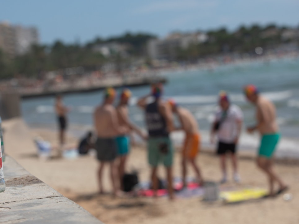 Alkoholflaschen neben den Sonnenbadenden am Strand von Arenal auf Mallorca.