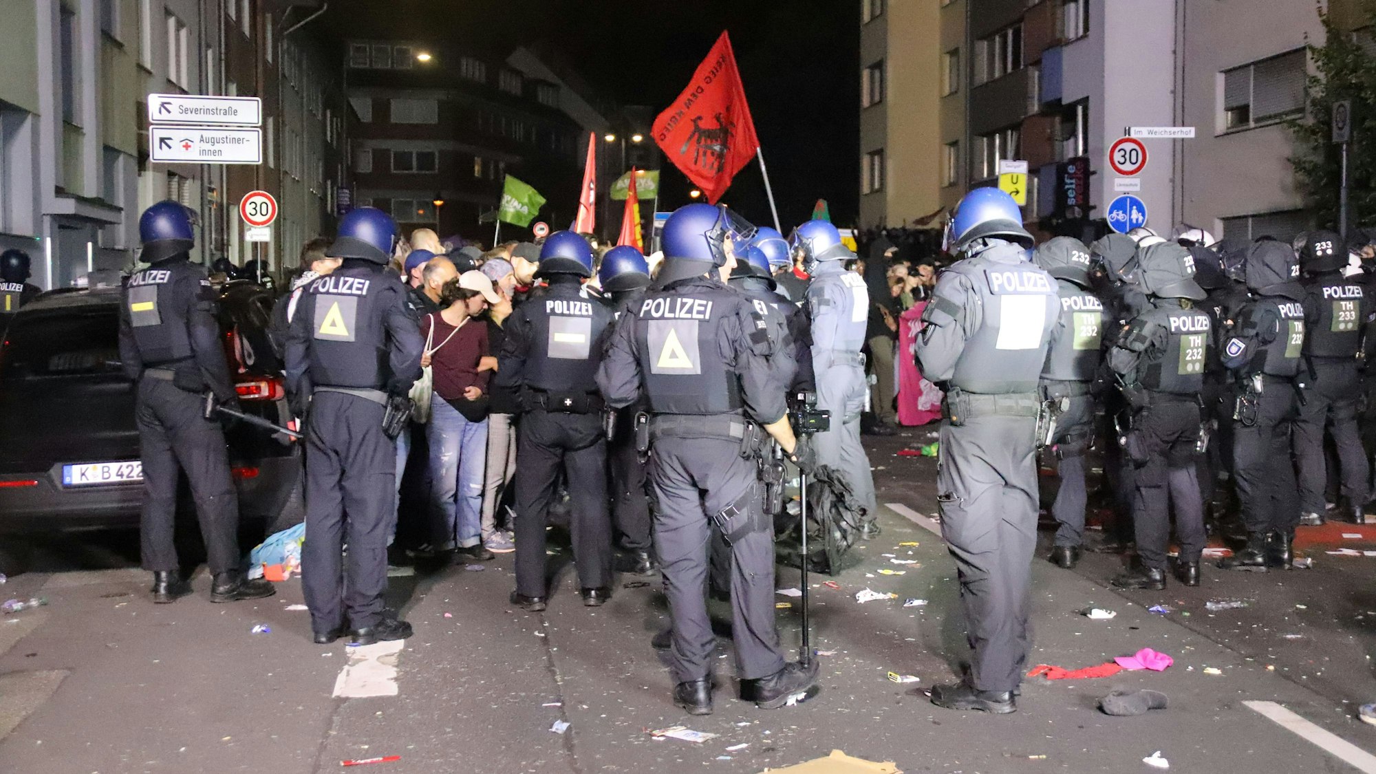 Polizeikräfte stehen Teilnehmenden einer Demo gegenüber.