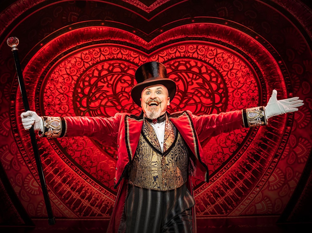 Darsteller von Moulin Rouge! Das Musical vor einem Herz-Bühnenbild
