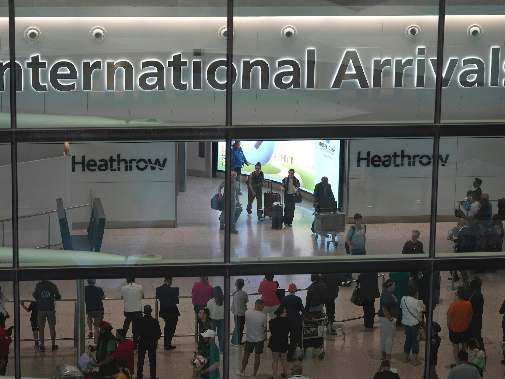 ARCHIV - 27.05.2023, Großbritannien, London: Passagiere kommen am International Arrivals auf dem Flughafen Heathrow in London an. (zu dpa: «Feuerwehr-Einsatz: Terminal am Flughafen Heathrow evakuiert») Foto: Kin Cheung/AP/dpa +++ dpa-Bildfunk +++