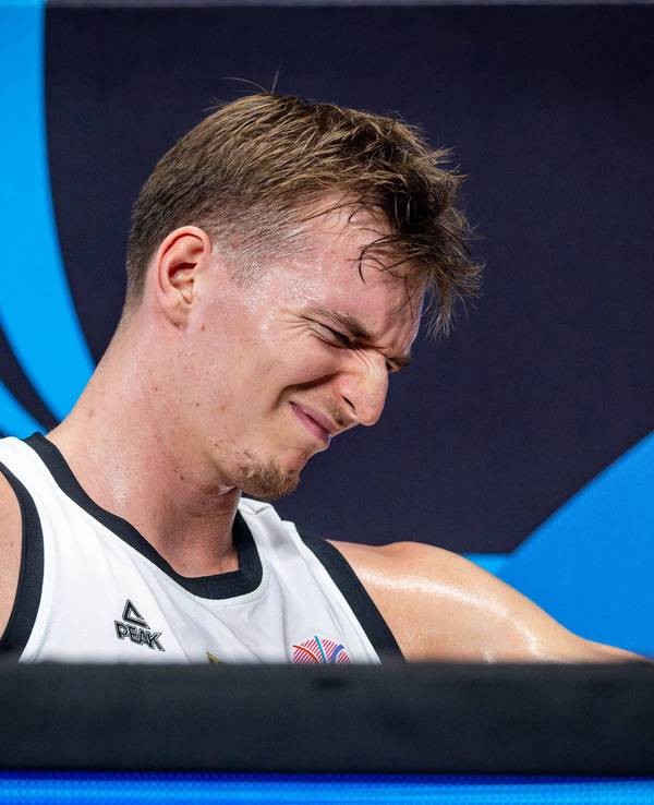 Justus Hollatz sitzt mit schmerzverzerrtem Gesicht an der Seitenlinie beim Spiel gegen Slowenien am 10. September 2025.