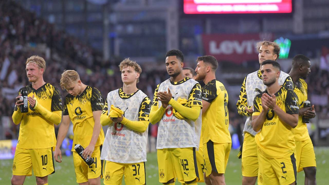 Die BVB-Profis stehen enttäuscht auf dem Platz und applaudieren den Fans.