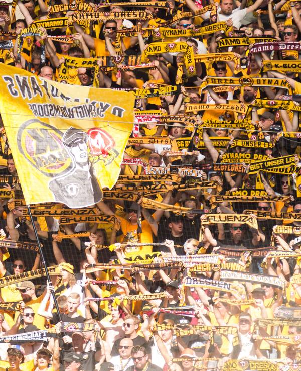Dynamo-Fans halten im Gästeblock ihre Schals hoch.