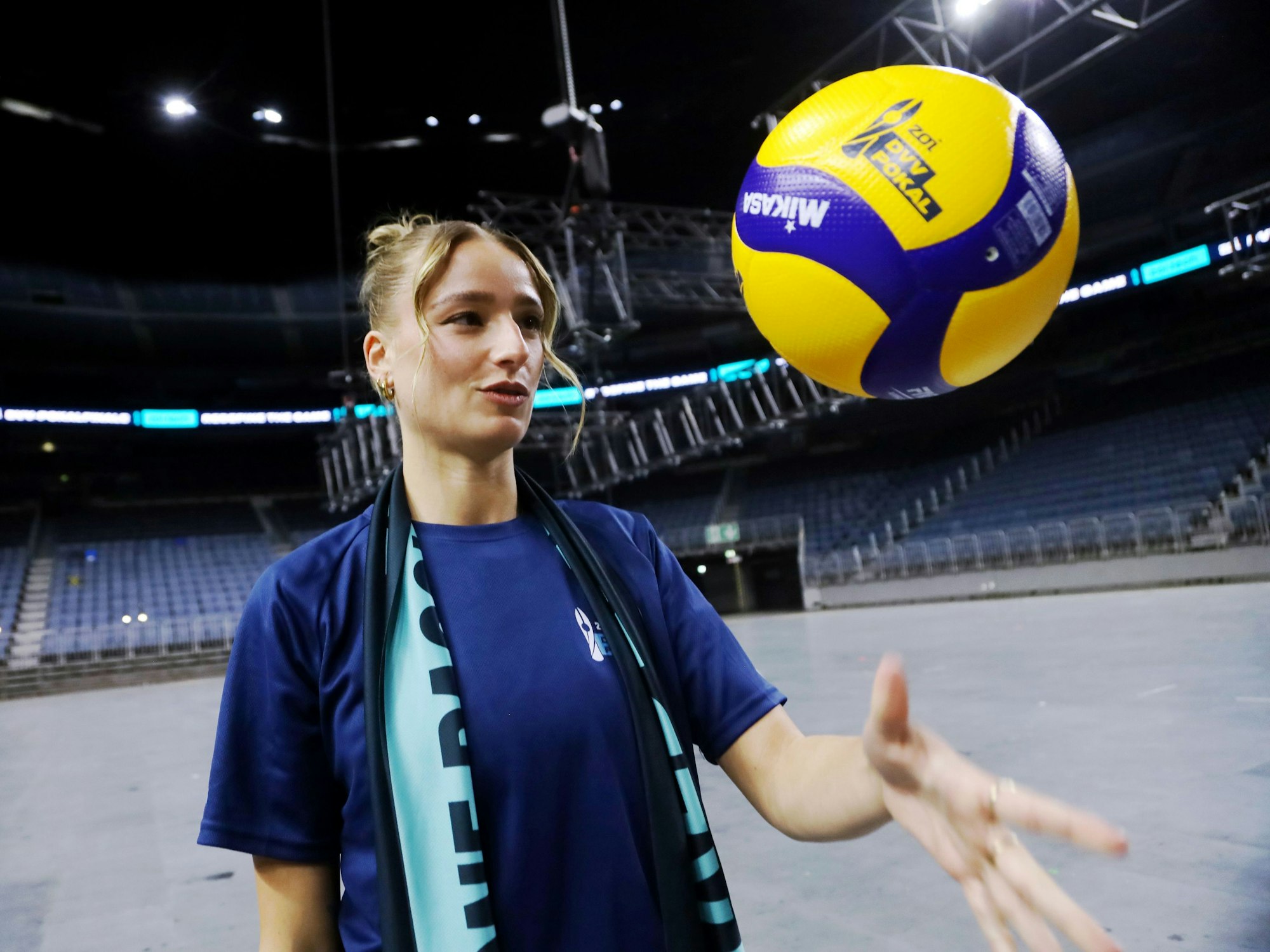 Elena Kömmling wirft einen Volleyball in die Luft.