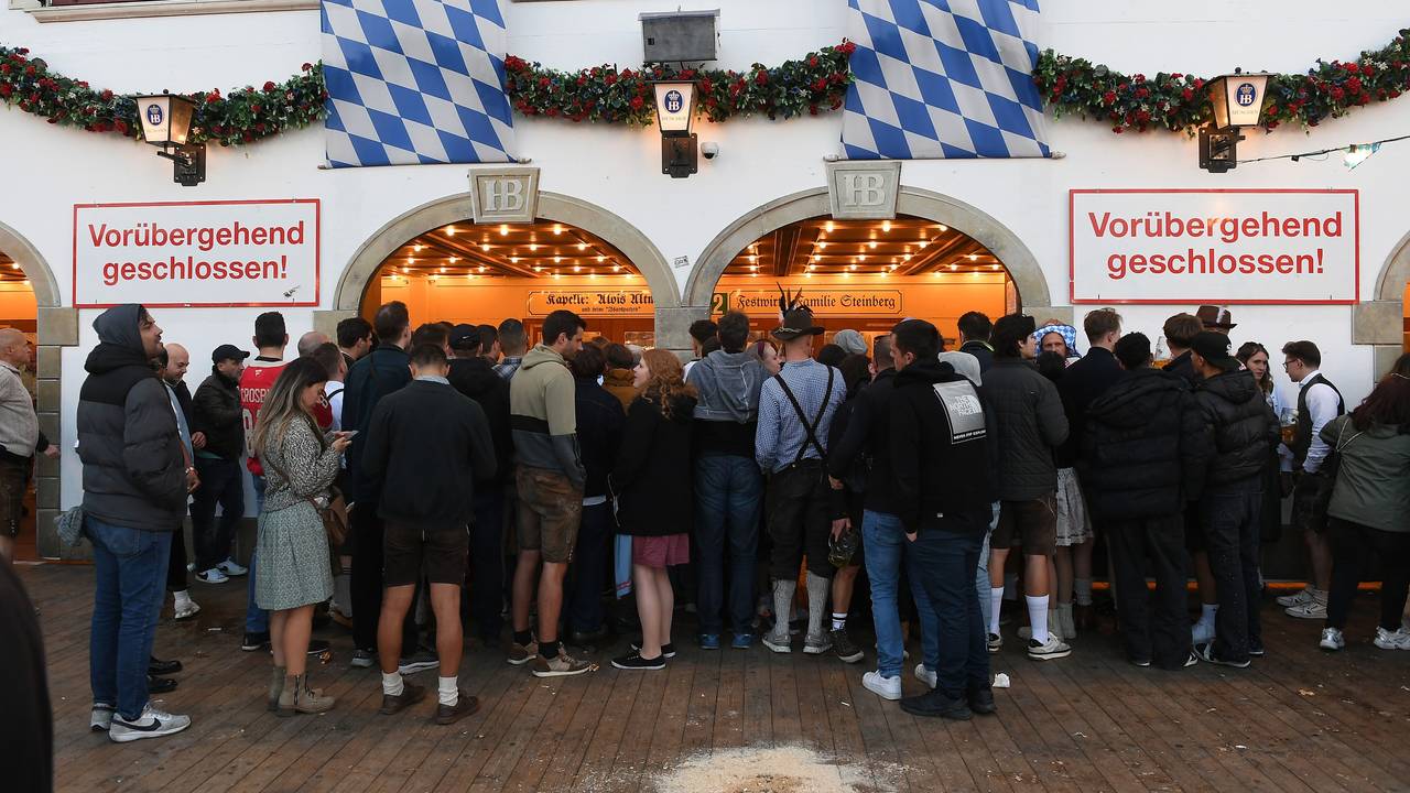 „Vorübergehend geschlossen“ steht am Eingang des Hofbräuzelt, vor dem zahlreiche Menschen stehen.