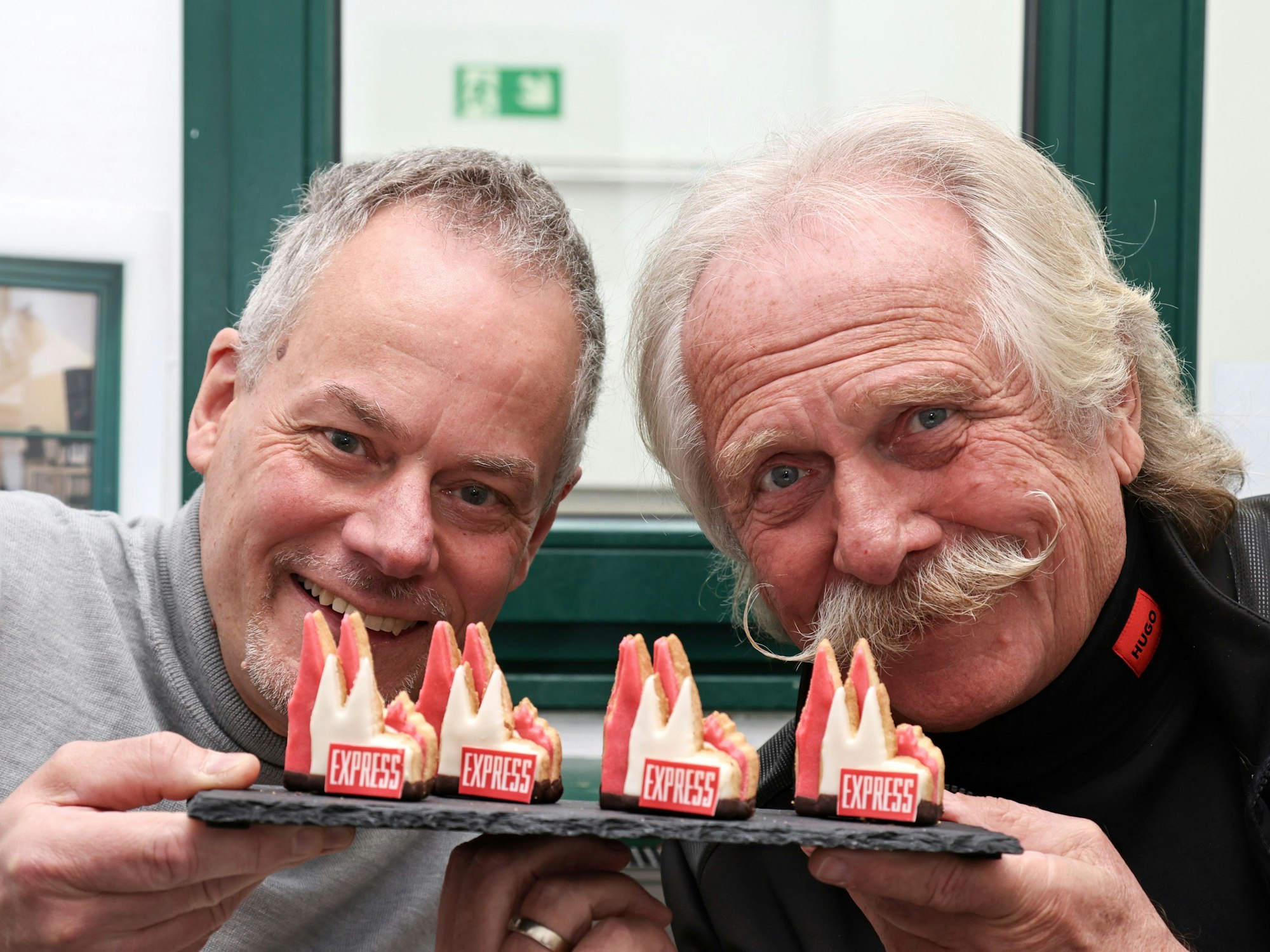 Henning Krautmacher und Marcel Seeger zeigen das EXPRESS-Dom-Plätzchen.