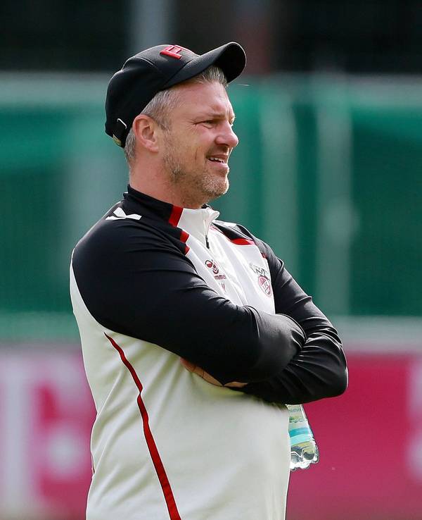 Lukas Kwasniok steht mit verschränkten Armen auf dem Trainingsplatz des 1. FC Köln.