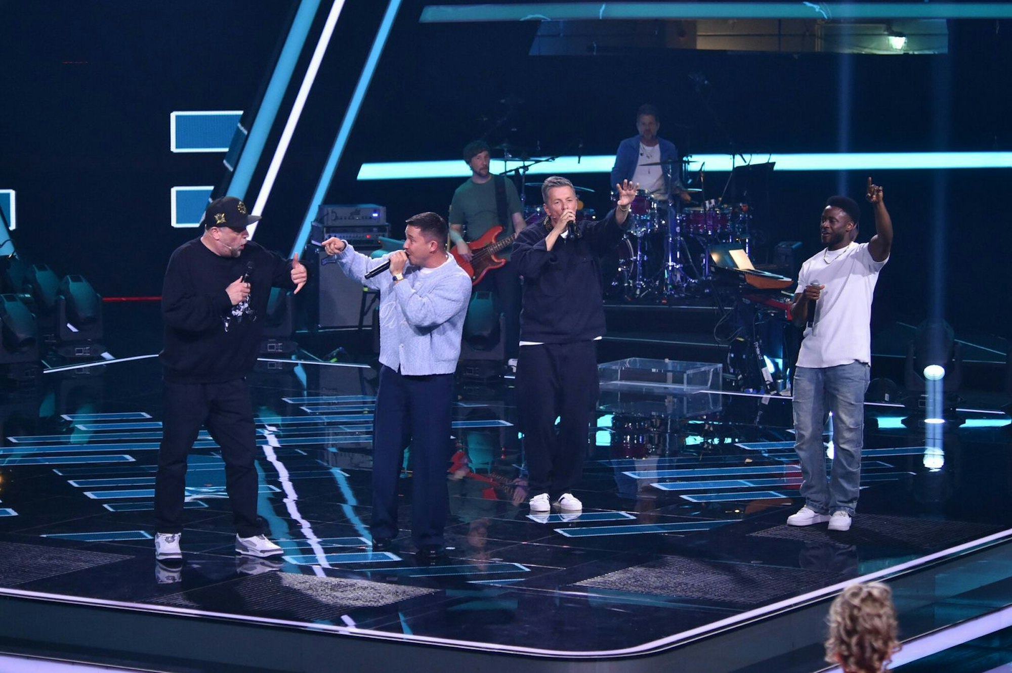 Mikro-Fight auf offer Bühne: Die Coaches Smudo, Nico und Michi lieferten sich ein Rap-Battle um den Show-Rückkehrer Clifford Dwenger. (Bild: Joyn/ André Kowalsk)