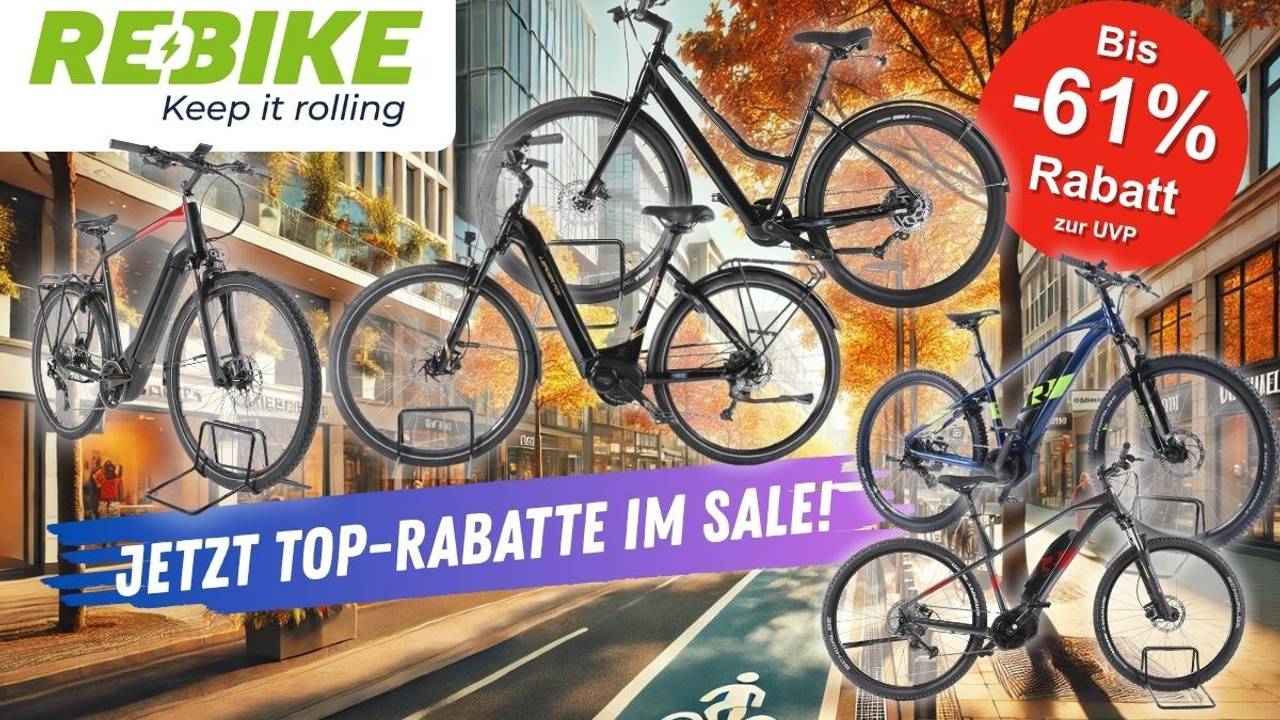 E-Mountain-Bikes, Trekking Bikes und City-E-Bikes vor einer herbstlichen Innenstadt-Kulisse. Mehrere bekannte E-Bike Marken und Hersteller sind vertreten.