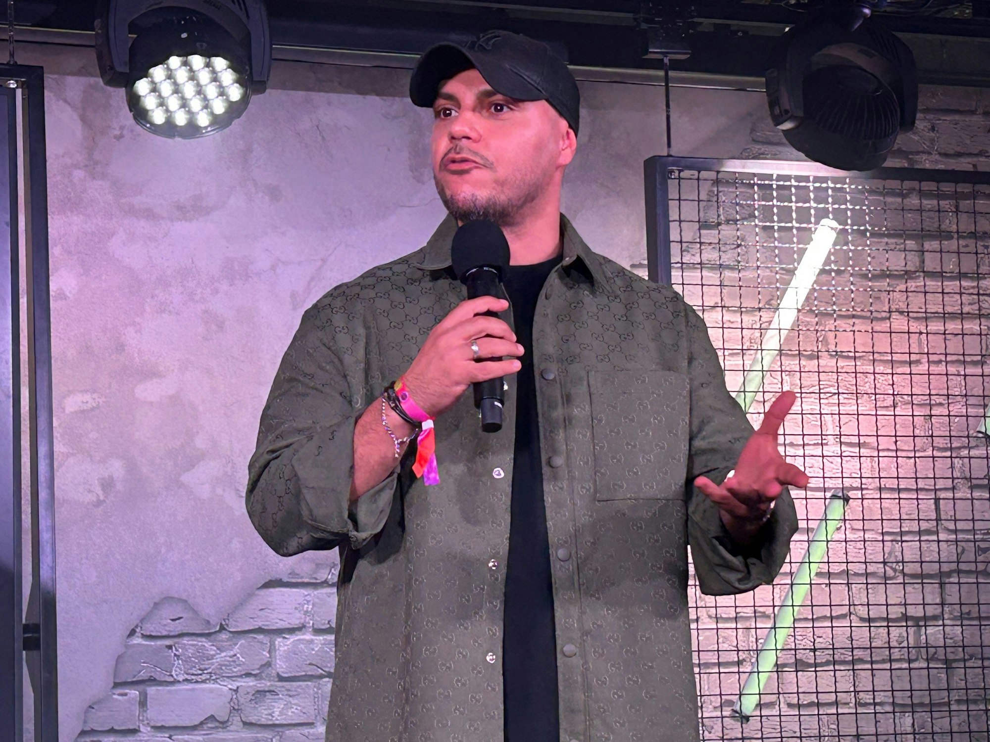 Comedian Osan Yaran steht auf der Bühne.