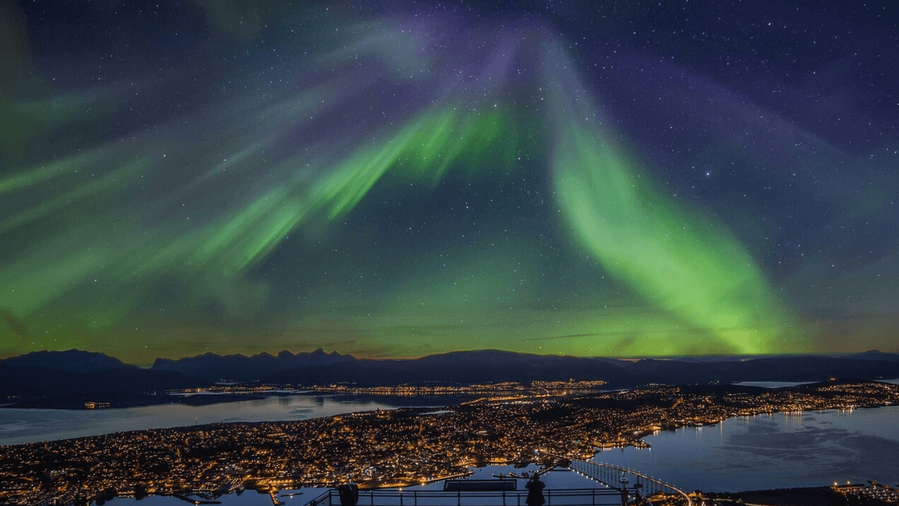 Das Bild zeigt die Polarlichter über der norwegischen Stadt Tromsø