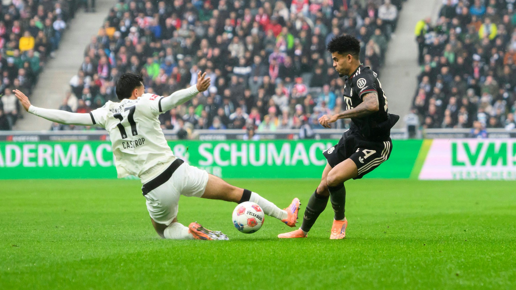 Jens Castrop grätscht mit offener Sohle in das Duell mit Luis Díaz.