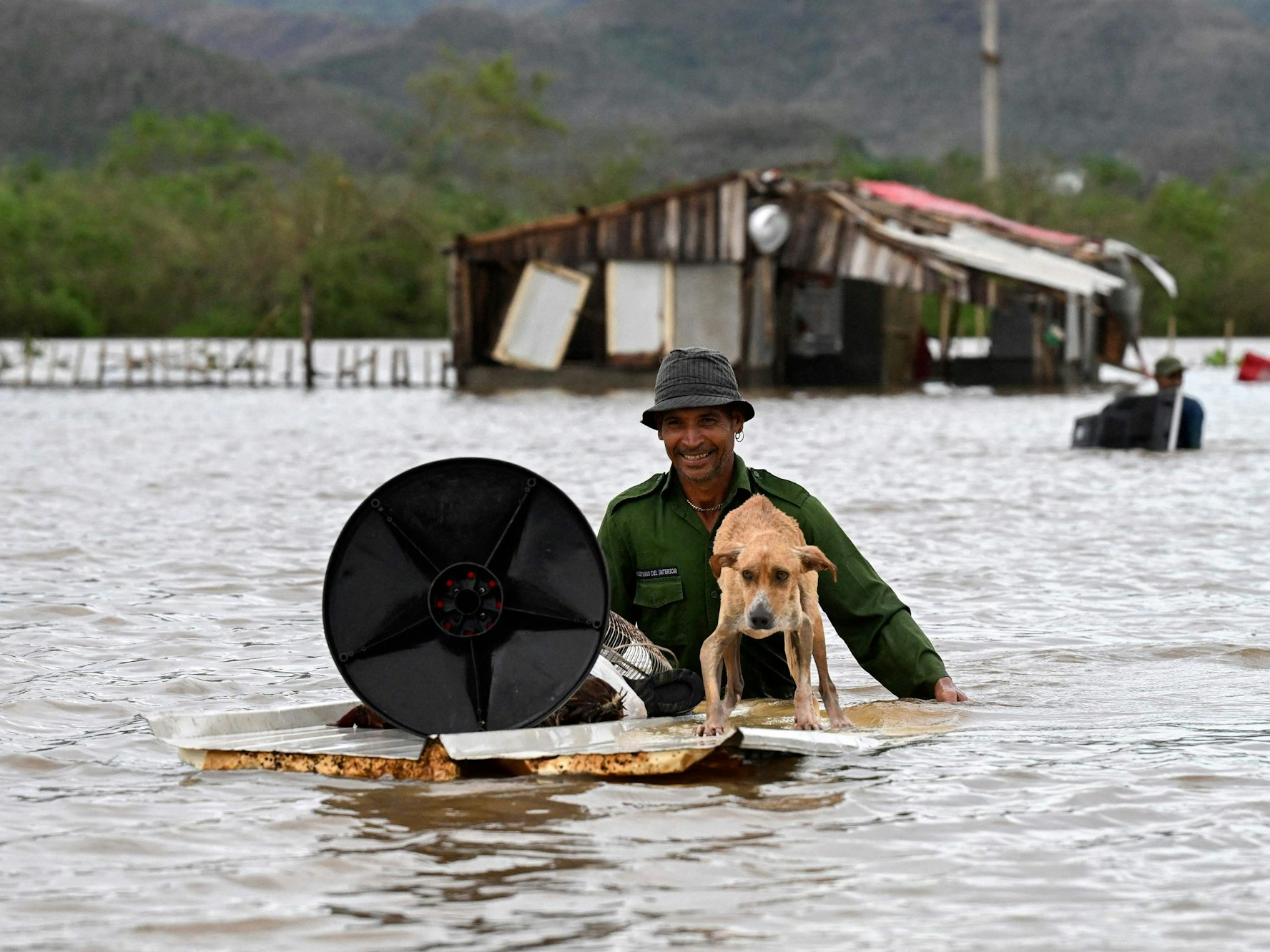Ein Bauer rettet seinen Hund und einige Habseligkeiten aus seinem überfluteten Haus, nachdem der Hurrikan „Melissa“ am 29. Oktober 2025 die Stadt San Miguel de Parada in der Provinz Santiago de Cuba heimgesucht hat.