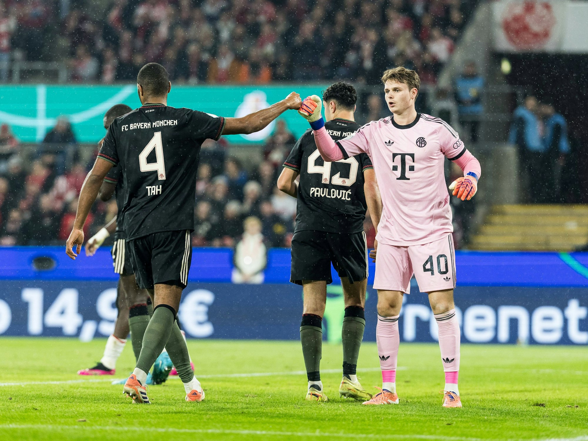 Jonas Urbig und Jonathan Tah klatschen sich ab.