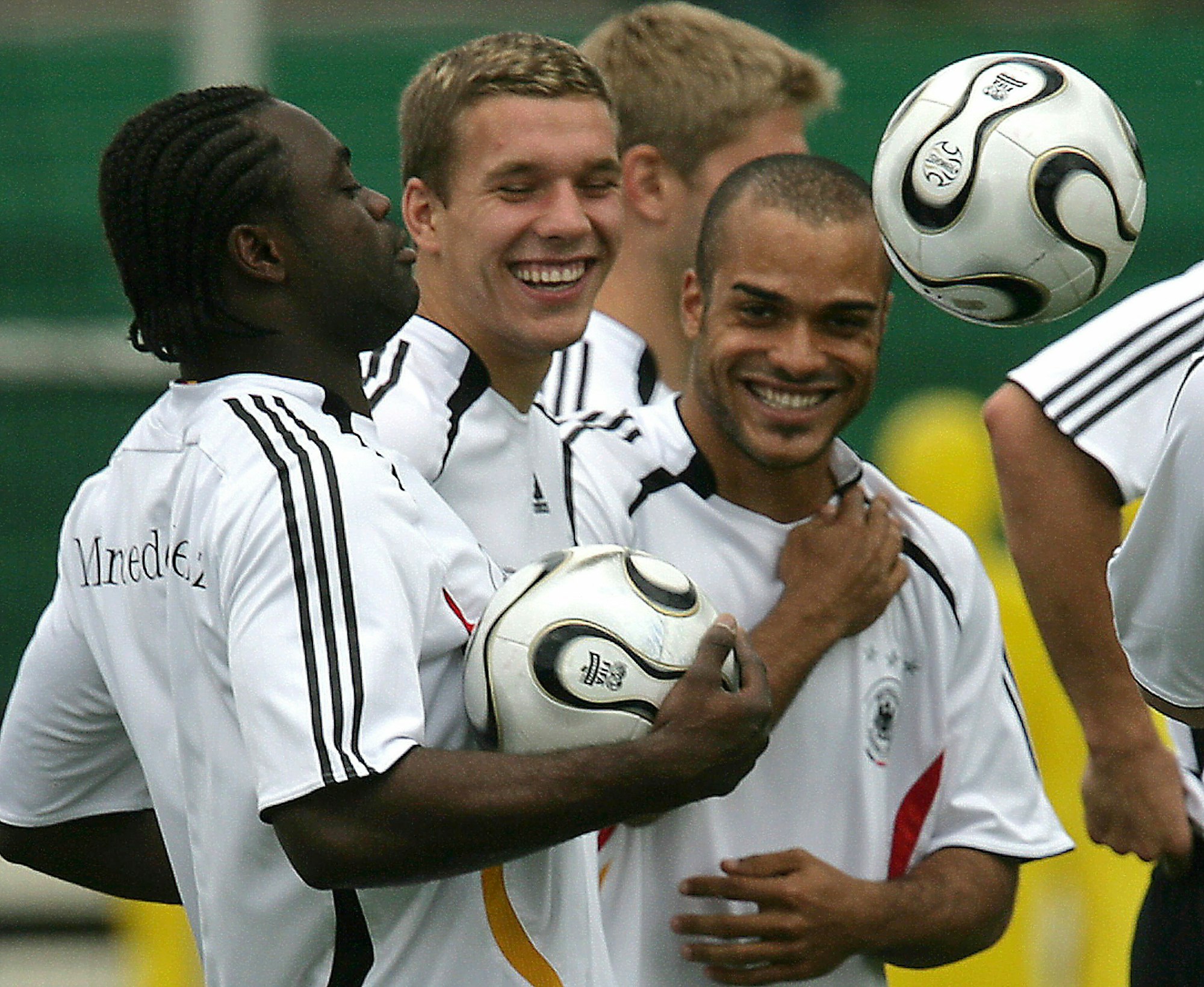 Germany's Gerald Asamoah (L-R), Lukas Podolski and David Odonkor have fun during the training session in Berlin on Thursday 22 June 2006. The german national soccer team prepares the next match against Sweden on Saturday 24 June 2006 in Munich. DPA/OLIVER BERG +++ dpa-Bildfunk +++