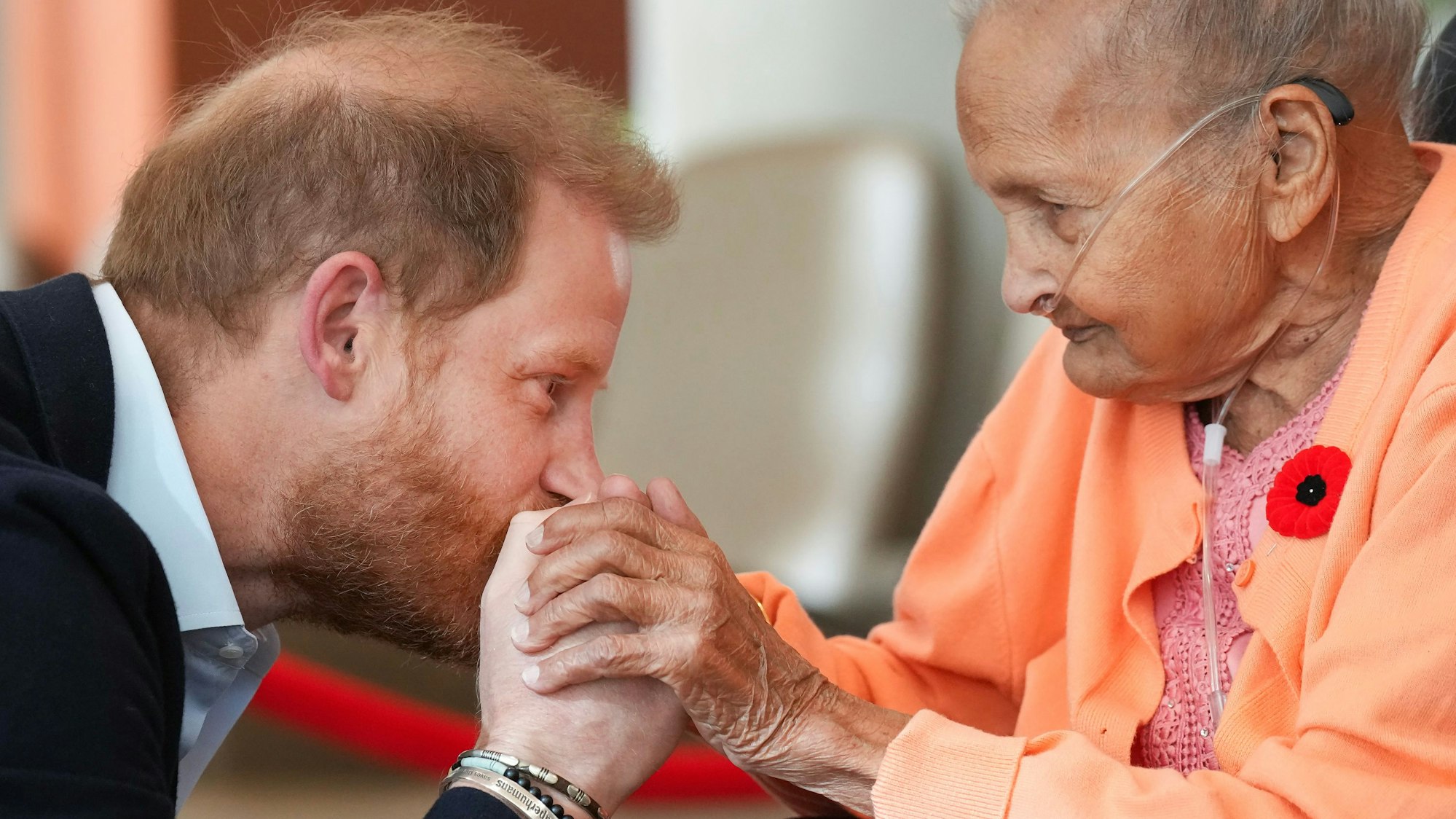 Prinz Harry küsst Villa Shah, 91, die Hand.