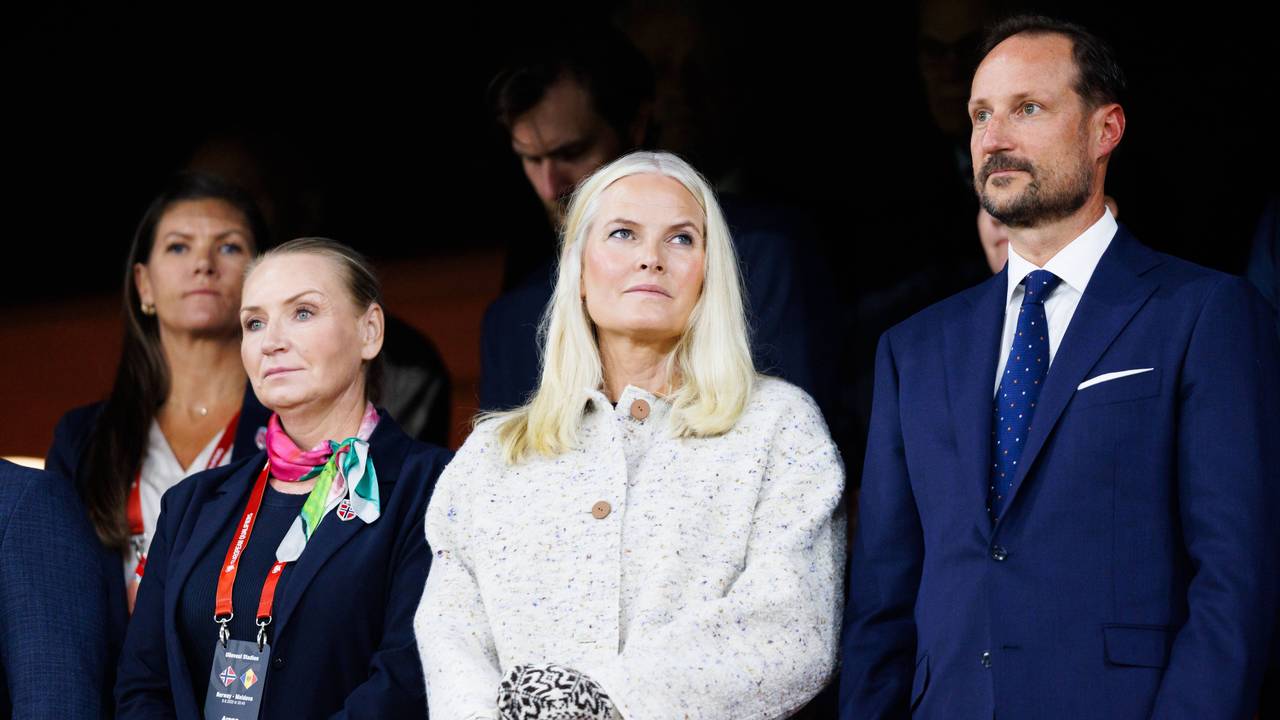 Mette-Marit steht neben Prinz Haakon.