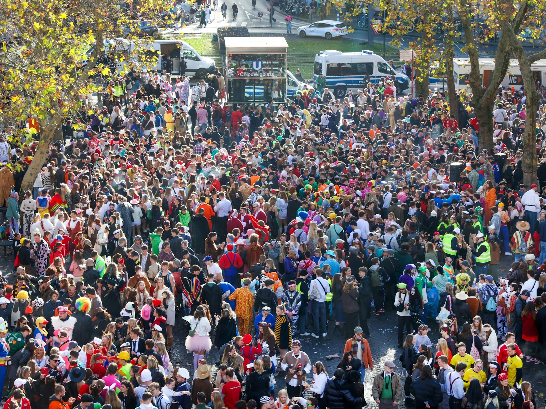Kostümierte Menschen stehen dicht gedrängt auf dem Chlodwigplatz.