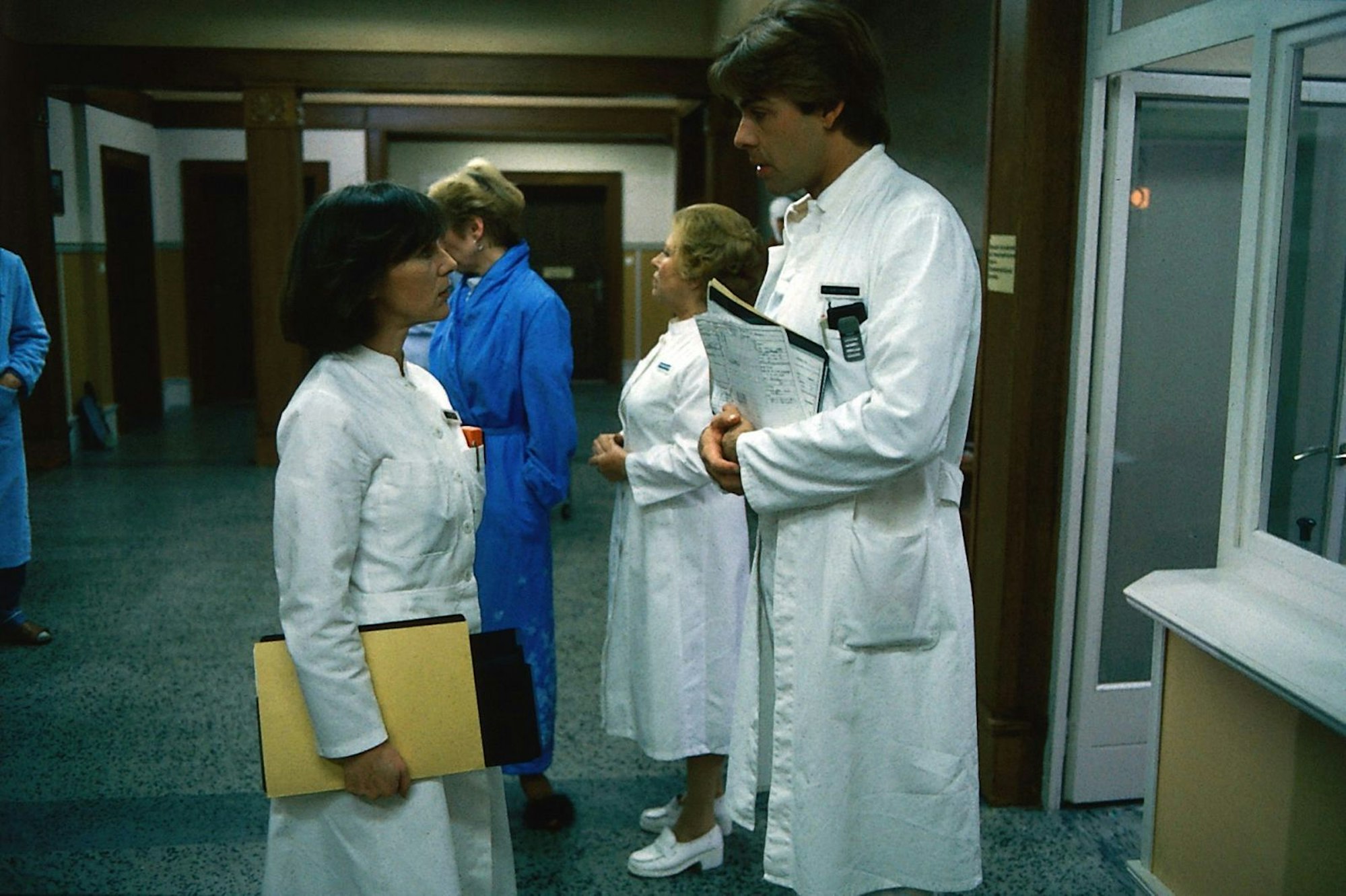 Udo Brinkmann (Sascha Hehn) sagt seiner Kollegin Elena Bach (Heidelinde Weis), dass sein Vater ganz überraschend in Urlaub gefahren sei. (Bild: ZDF / Thomas Waldhelm)