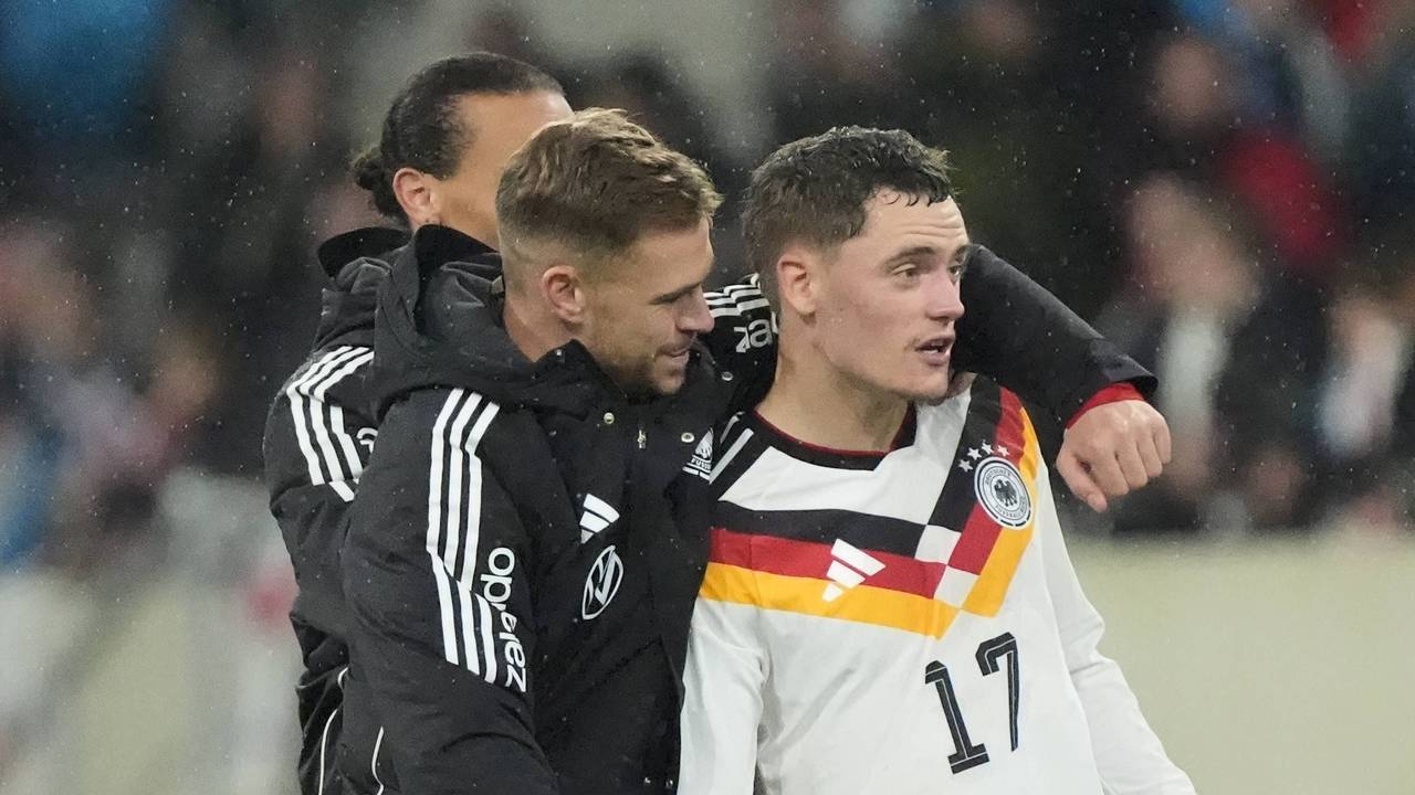 Joshua Kimmich umarmt Florian Wirtz nach dem Spiel.