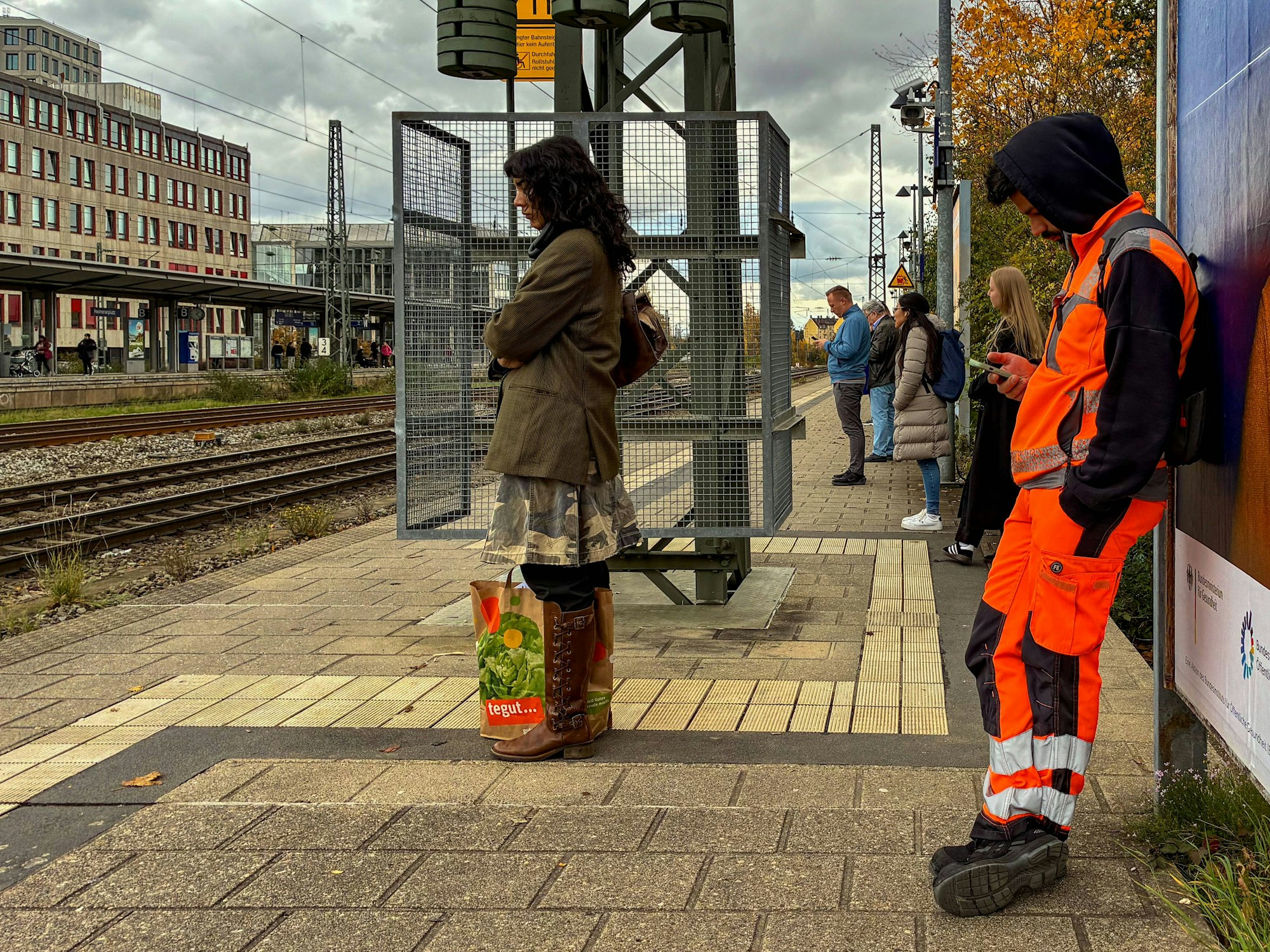 Das Symbolfoto zeigt wartende Reisende und Pendler an einem Bahnsteig. In Leichlingen kam es nun zu einem schweren Unfall.
