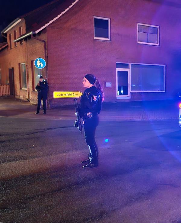 Eine Polizistin sichert neben einem Polizeifahrzeug eine Kreuzung. In der Gemeinde westlich von Hannover seien Schüsse gefallen, verletzt worden sei niemand, teilte eine Polizeisprecherin mit.