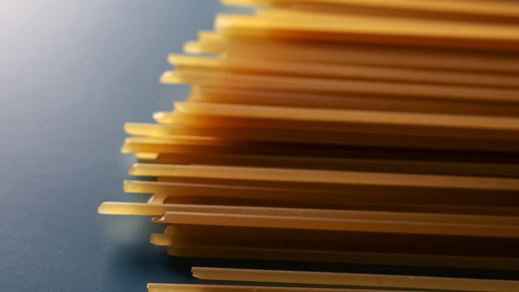 Ungekochte Spaghetti auf blauem Hintergrund