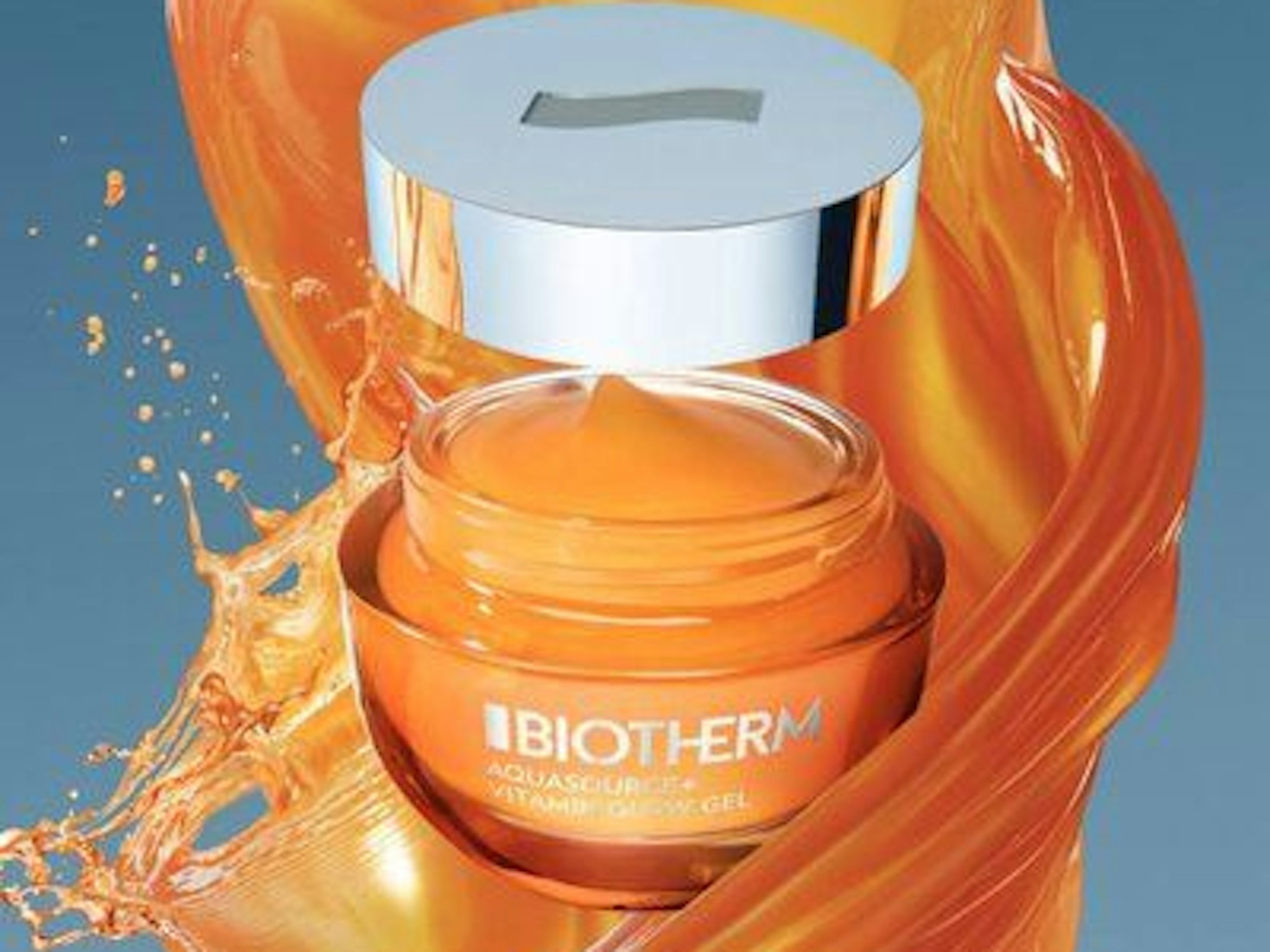 Ein orangefarbener Tiegel mit dunkelgelber Creme.